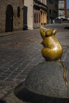 City attraction of tiny mouse street statue in old part of Klaipeda, Lithuania. City symbols, medieval towns, sunny day, cobbled pavement.