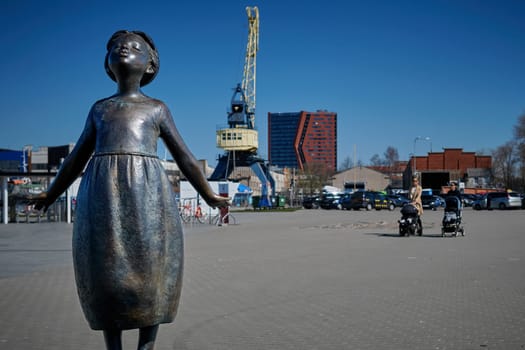 City attraction. Statue of unknown little girl in port of Klaipeda, Lithuania on sunny day.