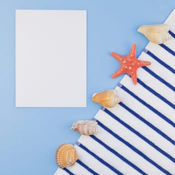 Creative square flat lay concept of summer travel vacations. Top view of beach towel and seashells and starfish on pastel blue background with copy space in minimal style, template for text
