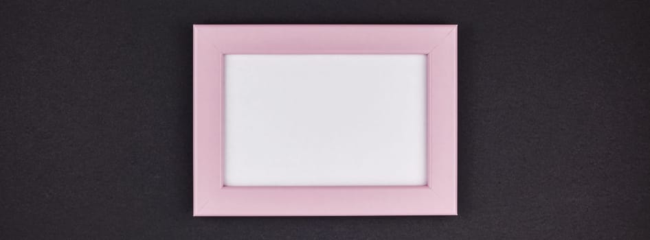 Mock up of a millennial pink frame on dark black color paper background with copy space in minimal style, template for text or your image mockup. Long wide banner