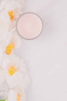 Beautiful blooming white peony flowers on marble background with copy space in minimal style, template for postcard, lettering, text or your design. Wedding invitation and celebration greeting concept