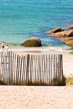 Wooden fence at Northern beach in France. Vertical shot