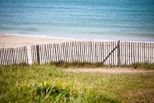 Wooden fence at Northern beach in France. Horizontal shot
