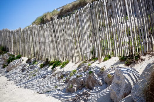 Wooden fence at Northern beach in France. Horizontal shot