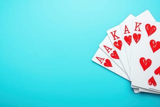 A collection of playing cards featuring the king of hearts prominently displayed, set against a bright blue background that enhances the vivid red and white design.