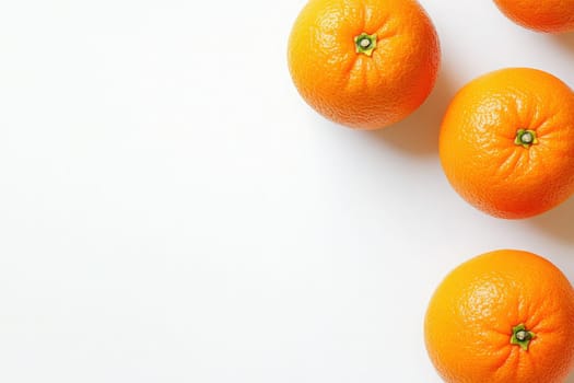 Four ripe oranges showcase their bright color against a clean white surface, highlighting their natural sheen and freshness.