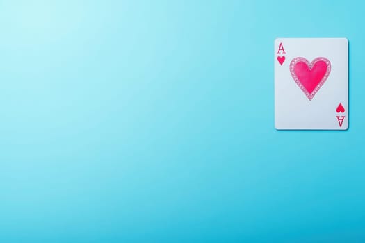 The king of hearts card rests on a solid turquoise background, presenting the vibrant heart design prominently. Its bright colors stand out, creating an eye-catching visual effect.