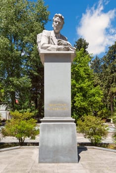 A statue of Bakhtiyar Vahabzadeh stands majestically in Shaki, Azerbaijan, celebrating the life and contributions of the renowned poet amid vibrant greenery and a tranquil setting