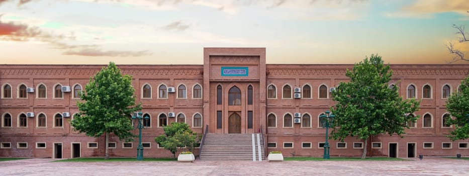 The stunning Imamzadeh Kompleks, or Complex in Ganja, Azerbaijan showcases beautiful architecture surrounded by lush greenery, inviting visitors to explore its rich history before sunset