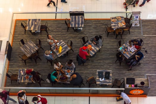 UAE, DUBAI - DECEMBER 25: people in a cafe in Dubai Mall shopping center on December 25, 2014. Top view