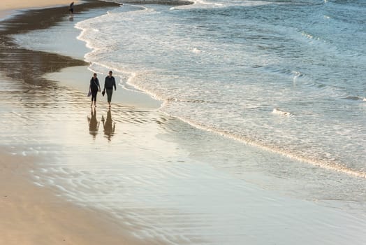 FRANCE, HENDAYE - SEPTEMBER 23: happy romantic couple walking on the atlantic beach. travel vacation on September 23, 2015