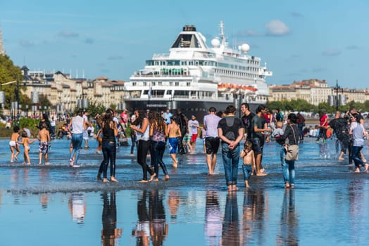 FRANCE, BORDEAUX - SEPTEMBER 20: Young people having fun and Famous dutch cruise ship Prinsendam in Bordeaux, France on September 20, 2015