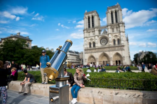 FRANCE, PARIS - JUNE 01: Telescope overlooking for Cathedral of Notre Dame in Paris on June 01, 2015