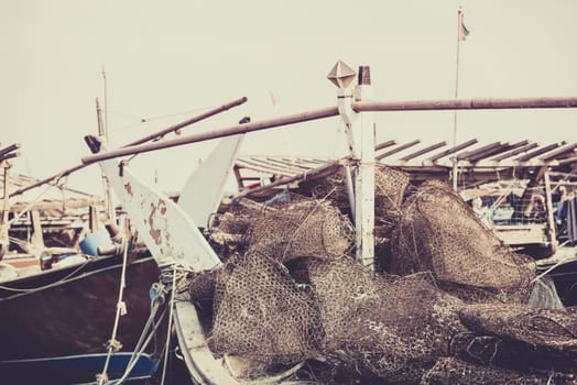 Old fishing boats with rusty metal nets in the Persian Gulf. Filtered shot