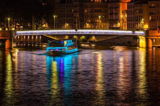 Cityscape of Lyon, France with reflections in the water at night