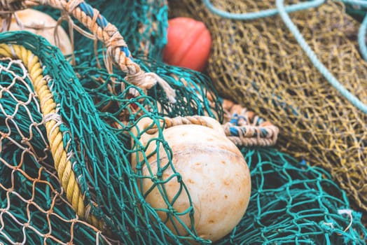 Green Fishing net with a buoys at the harbor. Close up