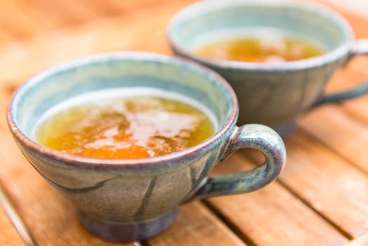 Norman apple cider in a typical ceramic cups. Shot with a selective focus