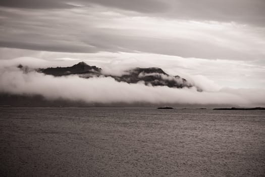 East Iceland Nature Landscape with rocks range in clouds. Sepia Toned image