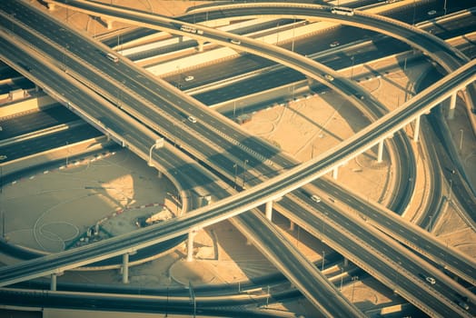 Top view of highway interchange in Dubai, UAE. Toned shot