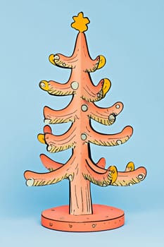 A whimsical Christmas tree stands out against a blue background, featuring colorful branches and a star on top for festive cheer.
