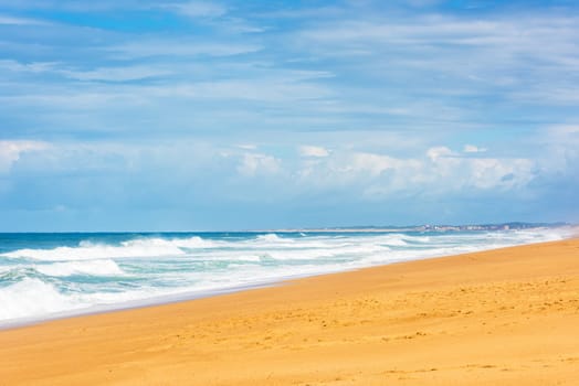 Long Sand Atlantic Beach with ocean waves. The Gironde Department, France. Shot with a selective focus