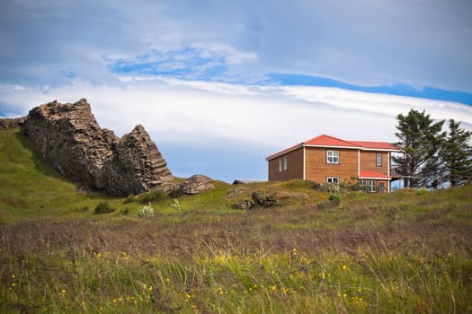 Landscape with rocks range and House in East Iceland. Horizontal shot