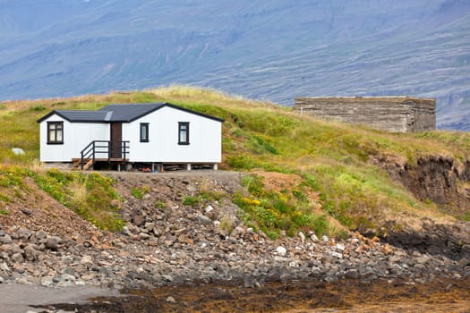 White Siding House at coastlineÊin East Iceland. Horizontal shot