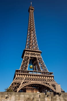 The Eiffel tower with blue clear sky in background Paris France