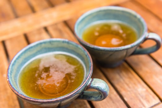 Norman apple cider in a typical ceramic cups. Shot with a selective focus