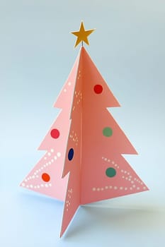 This decorative paper Christmas tree features vibrant colors and a gold star, perfect for holiday celebrations and festive decor.