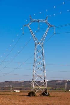 Electricity Power Pylons against Bright Blue Sky at a Beautiful Countryside
