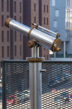 Telescope overlooking for city streets from above. Shot with a small GRIP
