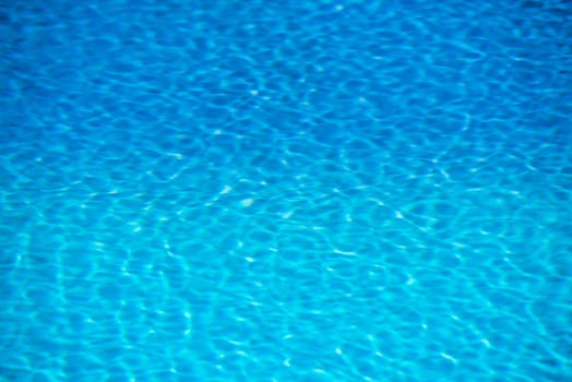 Clear transparent pool water background. Filtered blur shot