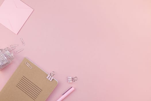 Top view flat lay of woman workspace desk styled design office supplies with copy space on a millennial pink color paper background minimal style. Template for feminine blog social media