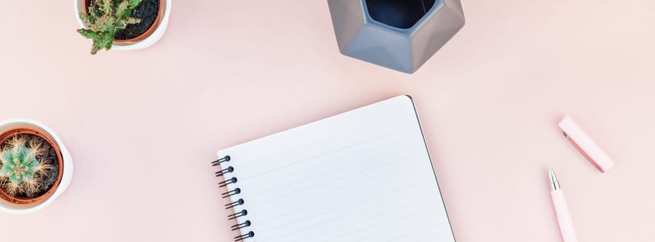 Long wide banner of workspace desk styled design office supplies and cactuses succulents with copy space millennial pink color paper background minimal style. Template for feminine blog social media