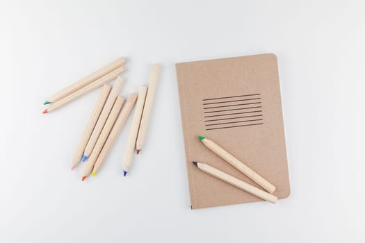 Creative top view flat lay of workspace desk styled recycled brown design office supplies with copy space on a white table background minimal eco style. Concept of environmental protection