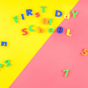 Square Creative flat lay back to school concept with welcome letters message on bright yellow and pink paper background with copy space, template for text or design