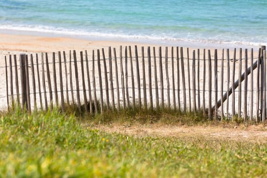 Wooden fence at Northern beach in France. Horizontal shot