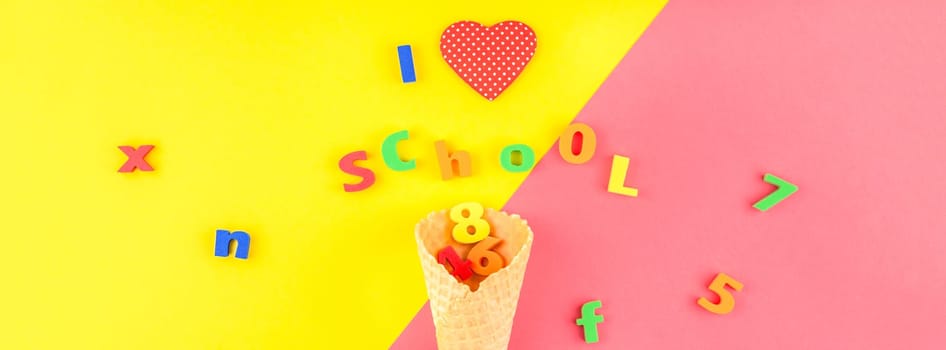Creative flat lay back to school concept with waffle cone and welcome letters message on bright yellow and pink paper background with copy space, template for text or design. Long wide banner