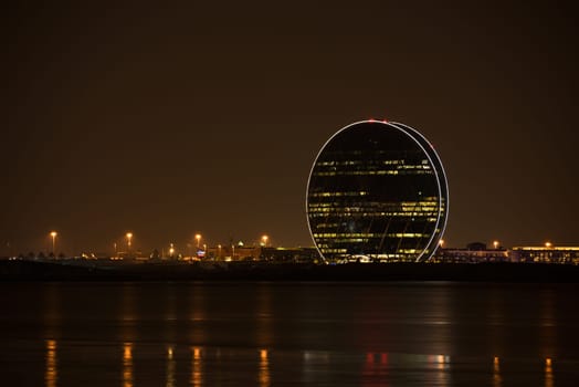UAE, ABU DHABI - DECEMBER 20: View of Aldar headquarters building and night skyline of Abu Dhabi, UAE on December 20, 2014