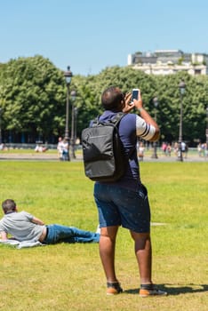 FRANCE, PARIS - JUNE 06: Man taking pictures on the street on June 06, 2015