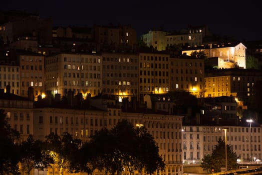 Cityscape of Lyon, France with reflections in the water at night