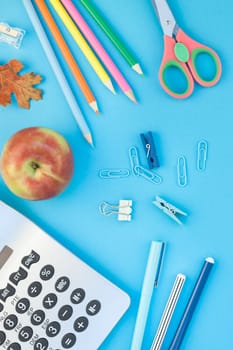 Creative flat lay top view back to school concept with color school and office supplies on bright turquoise paper table frame background with copy space, template for text or design