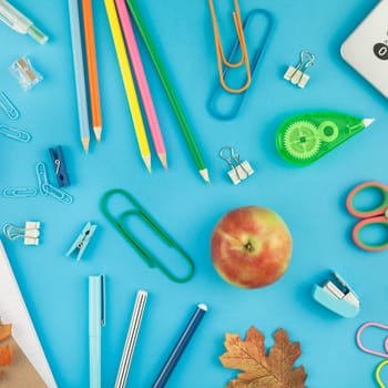 Square Creative flat lay top view back to school concept with color school and office supplies on bright turquoise paper table frame background with copy space, template for text or design