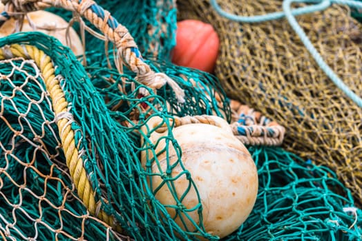 Green Fishing net with a buoys at the harbor. Close up