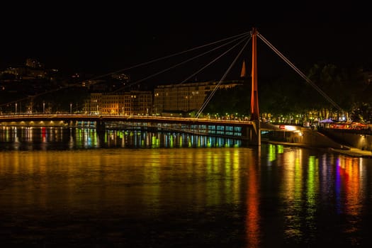 Cityscape of Lyon, France with reflections in the water at night