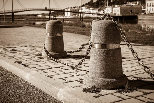 Stub posts linked in a chain on a quay in a small Portugal town
