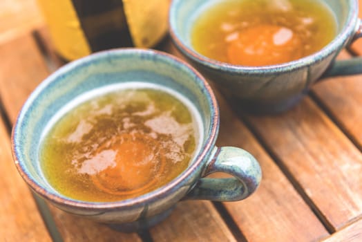 Norman apple cider in a typical ceramic cups. Shot with a selective focus