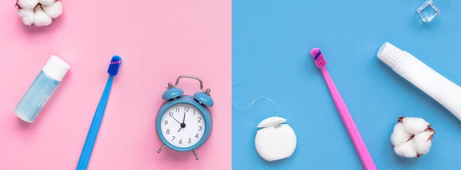 Teeth hygiene and oral dental care products and alarm clock on color pink and blue background copy space. Blank tube of toothpaste and brushes. Flat lay, top view composition, mockup. Morning concept