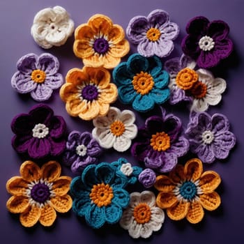 A collection of crocheted flowers in various colors, including white, purple, yellow, and teal. The flowers are arranged on a purple background. High quality photo